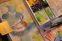 a watercolor painting of a duck on a table